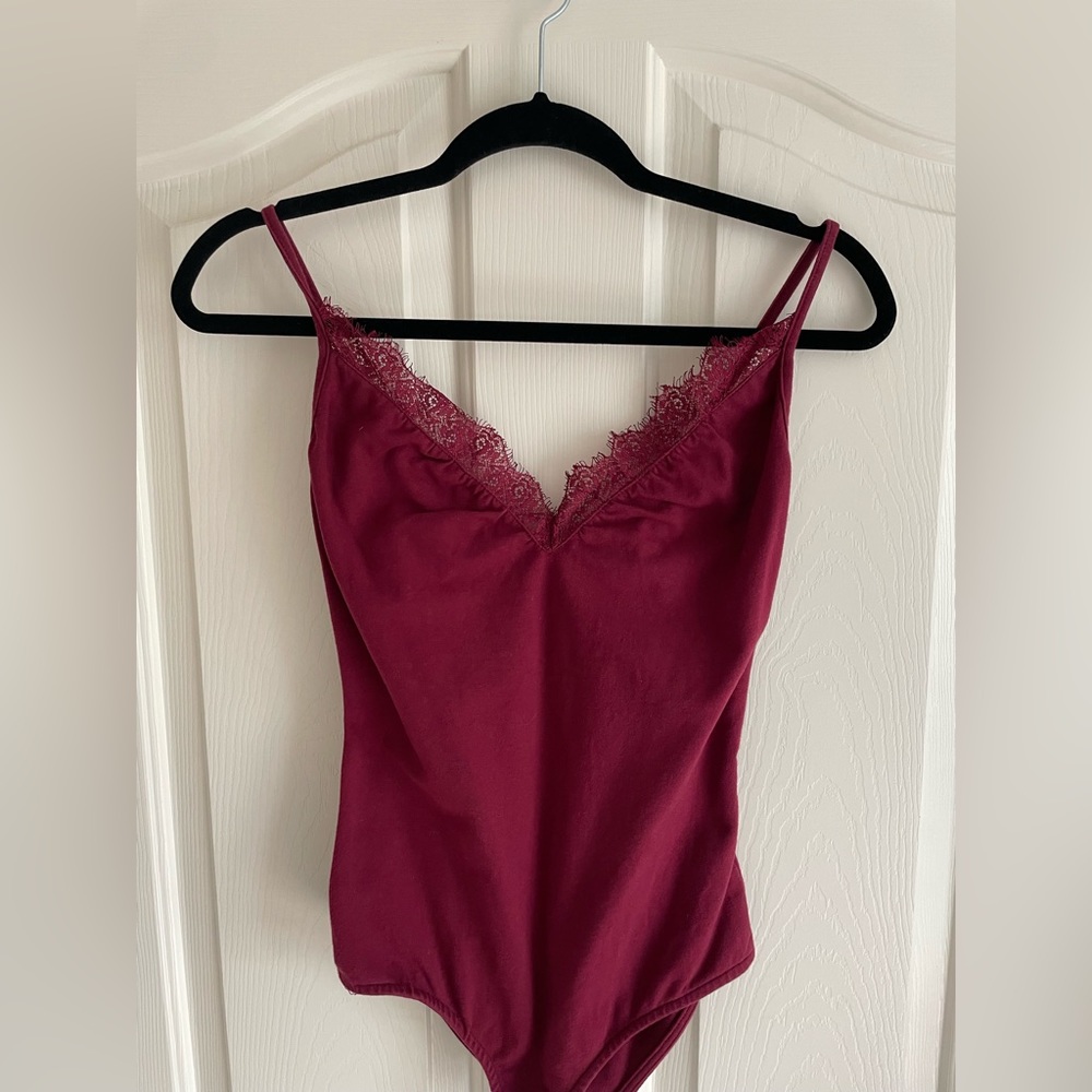 Burgundy/Maroon tank top bodysuit with lace detail.